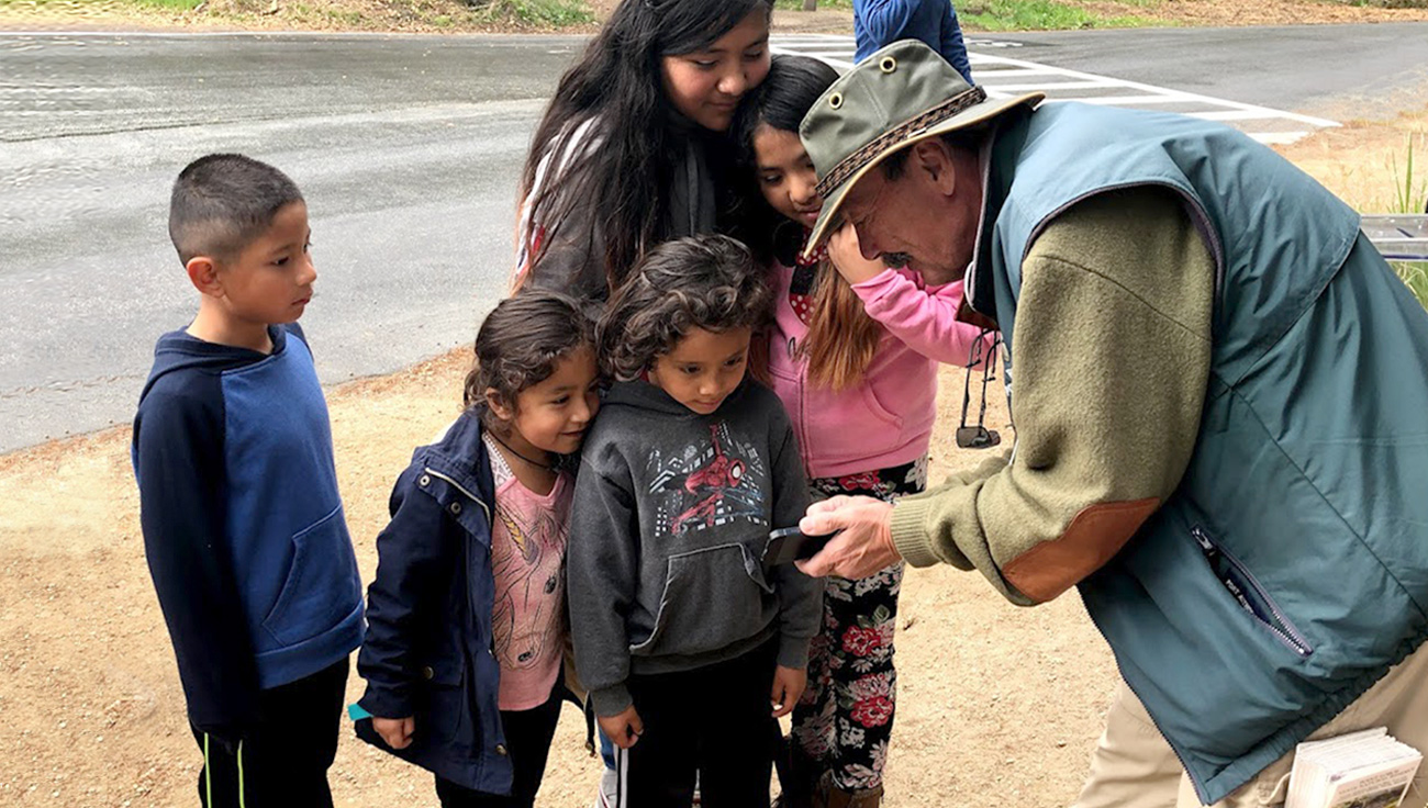 Photo of PLF Docent helping family at Point Lobos State Natural Reserve. Photo credit: Scott Whitman.